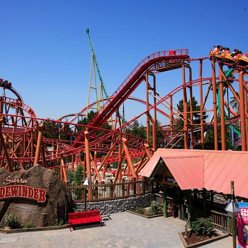 The image shows a colorful roller coaster named 